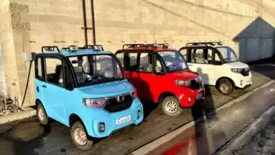Three Changzhou ChangLi S1-Pro micro electric vehicles parked in a row, featuring blue, red, and white models, showcasing the compact and affordable design of the world's cheapest car of 2024.