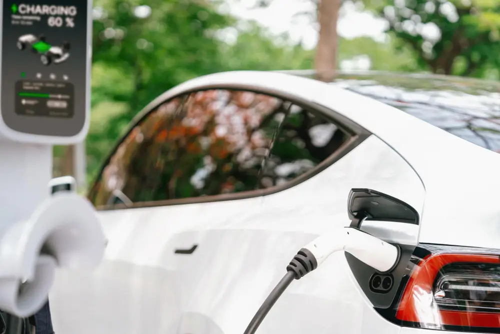 A Chinese electric vehicle charging at a station, highlighting the competition and market impact on U.S. automakers